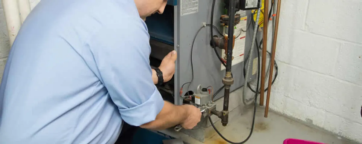 Furnace repair technician inspecting and servicing a home heating system in Tampa, FL