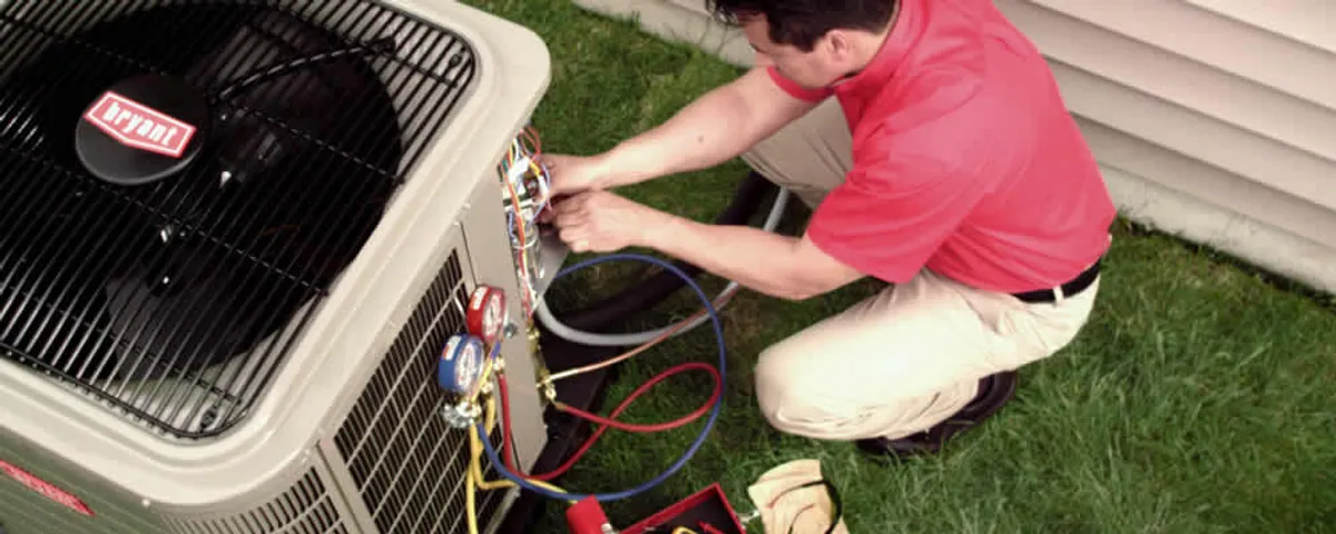 HVAC technician servicing an outdoor air conditioner unit in Tampa, FL