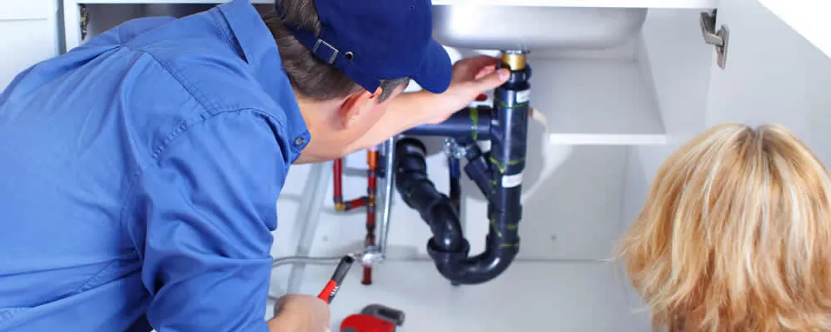 Plumber repairing under-sink drain pipes and fittings in Tampa, FL